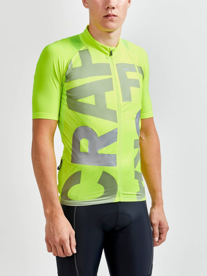 Person wearing a bright green cycling jersey with &