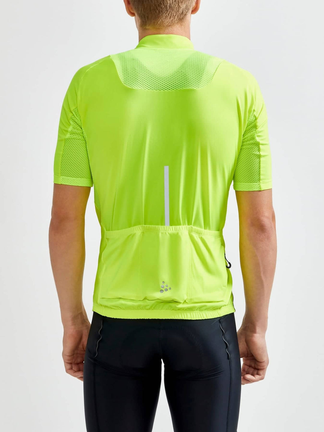 Person wearing a bright green cycling jersey on a white background