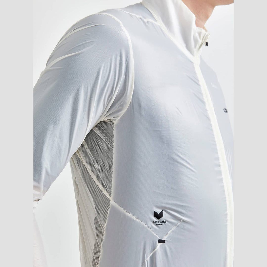 Close-up of a white athletic jacket with reflective stripes on a plain background