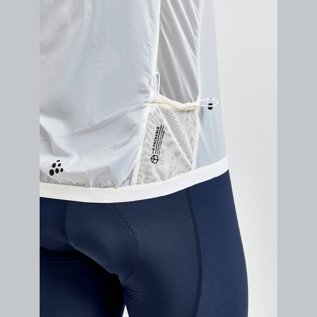 Close-up of a person wearing navy cycling shorts with a white jacket.