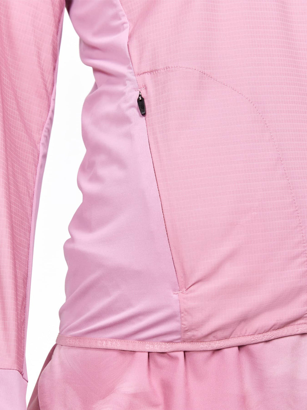 Close-up of a pink jacket with a pocket detail on a white background