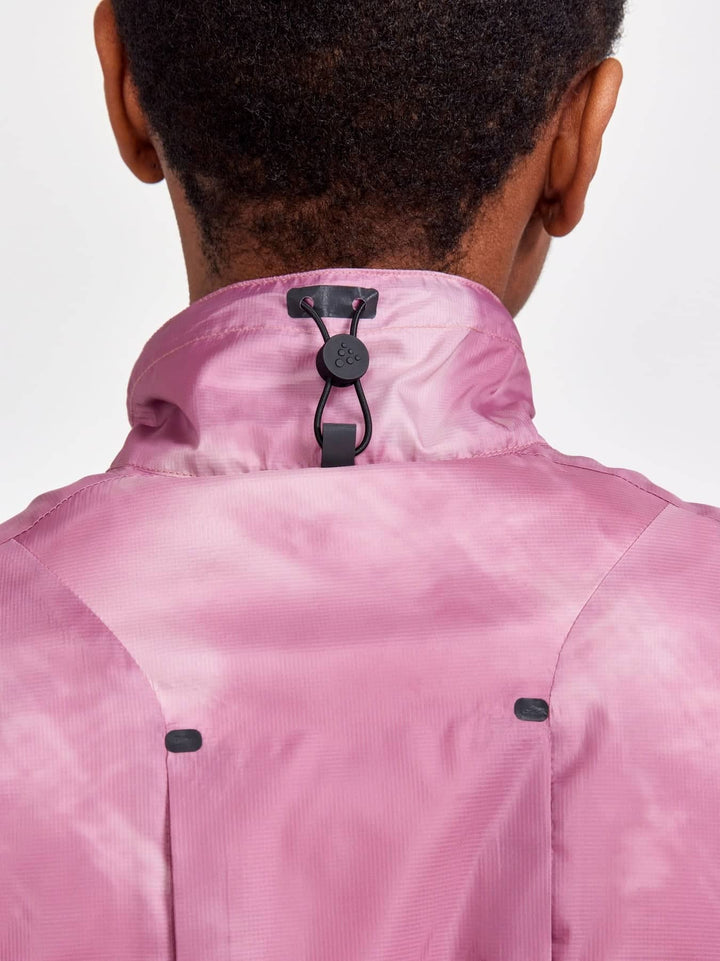 Pink jacket with black buttons on a plain background