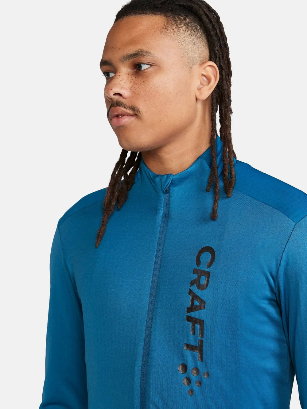 Person wearing a blue athletic jacket with 'Craft' branding on a white background