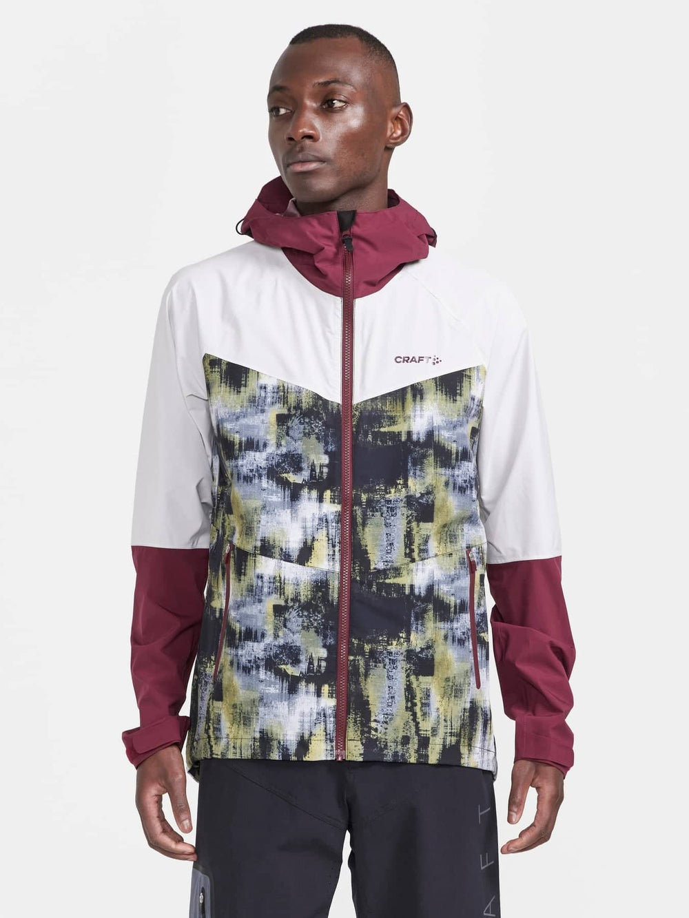 Man wearing a colorful jacket with a white background