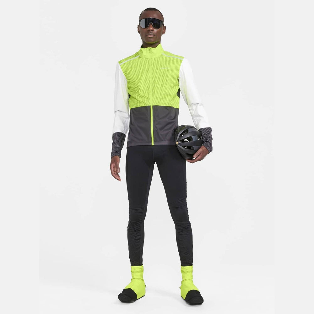 Person wearing a reflective cycling outfit with a helmet on a white background