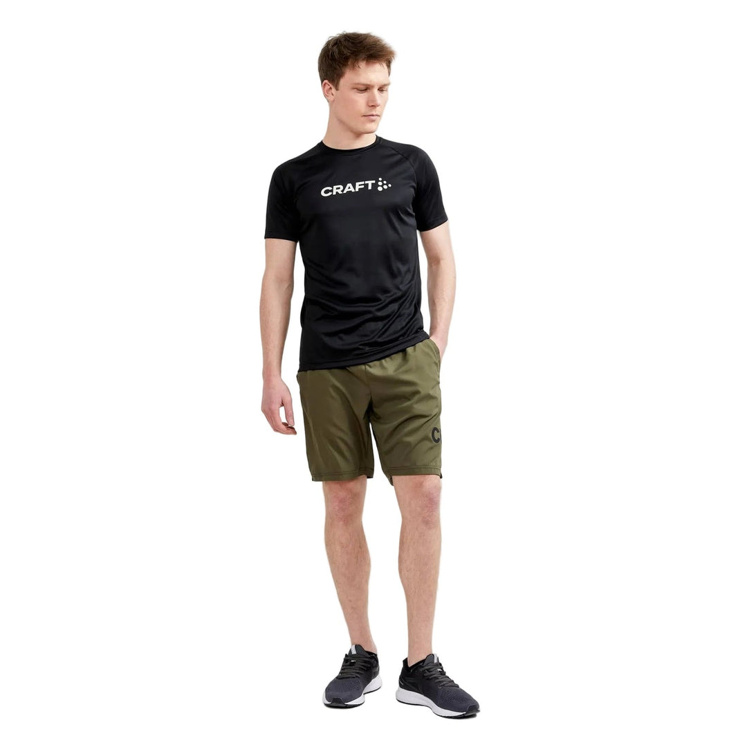 Male model wearing Craft Core Unify Logo Tee in Black, casual athletic t-shirt designed for everyday comfort and active lifestyles.