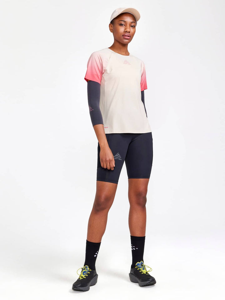 Craft Pro Trail SS Tee Women’s in Ecru Multi, lightweight breathable trail running shirt with moisture-wicking performance and athletic fit. ON MODEL