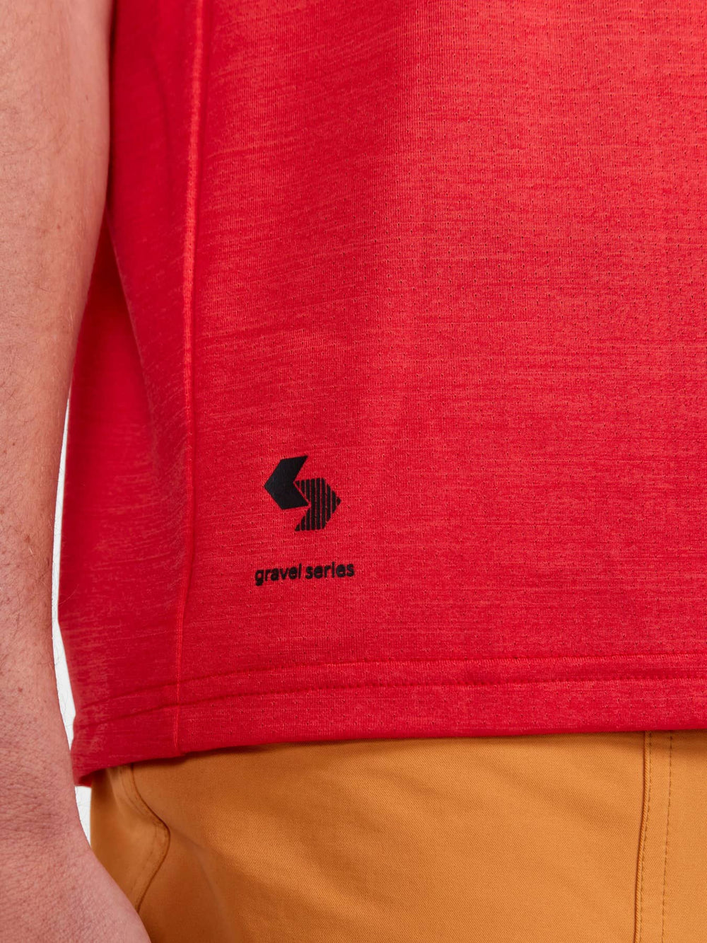 Red shirt with a logo on the sleeve, worn by a person.