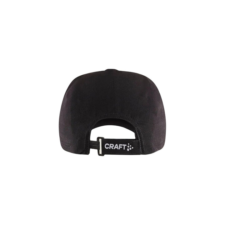 Black cap with a brand logo on a beige background