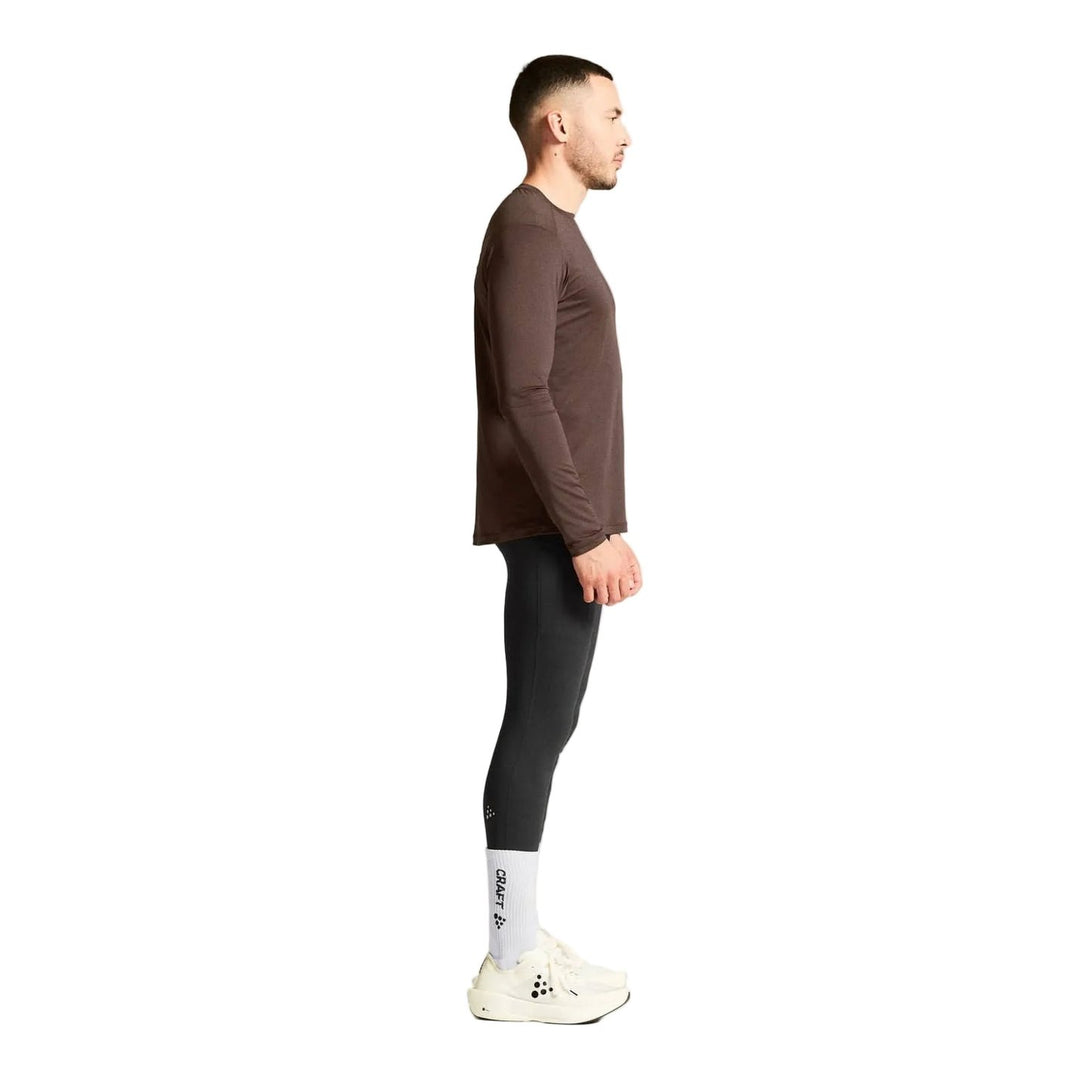 Side profile of male athlete wearing Craft ADV Essence LS Tee 2 Men&