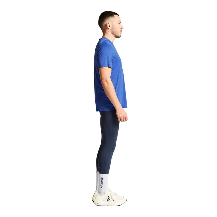Side profile of male athlete wearing Craft Core Essence SS Tee 2 Men&