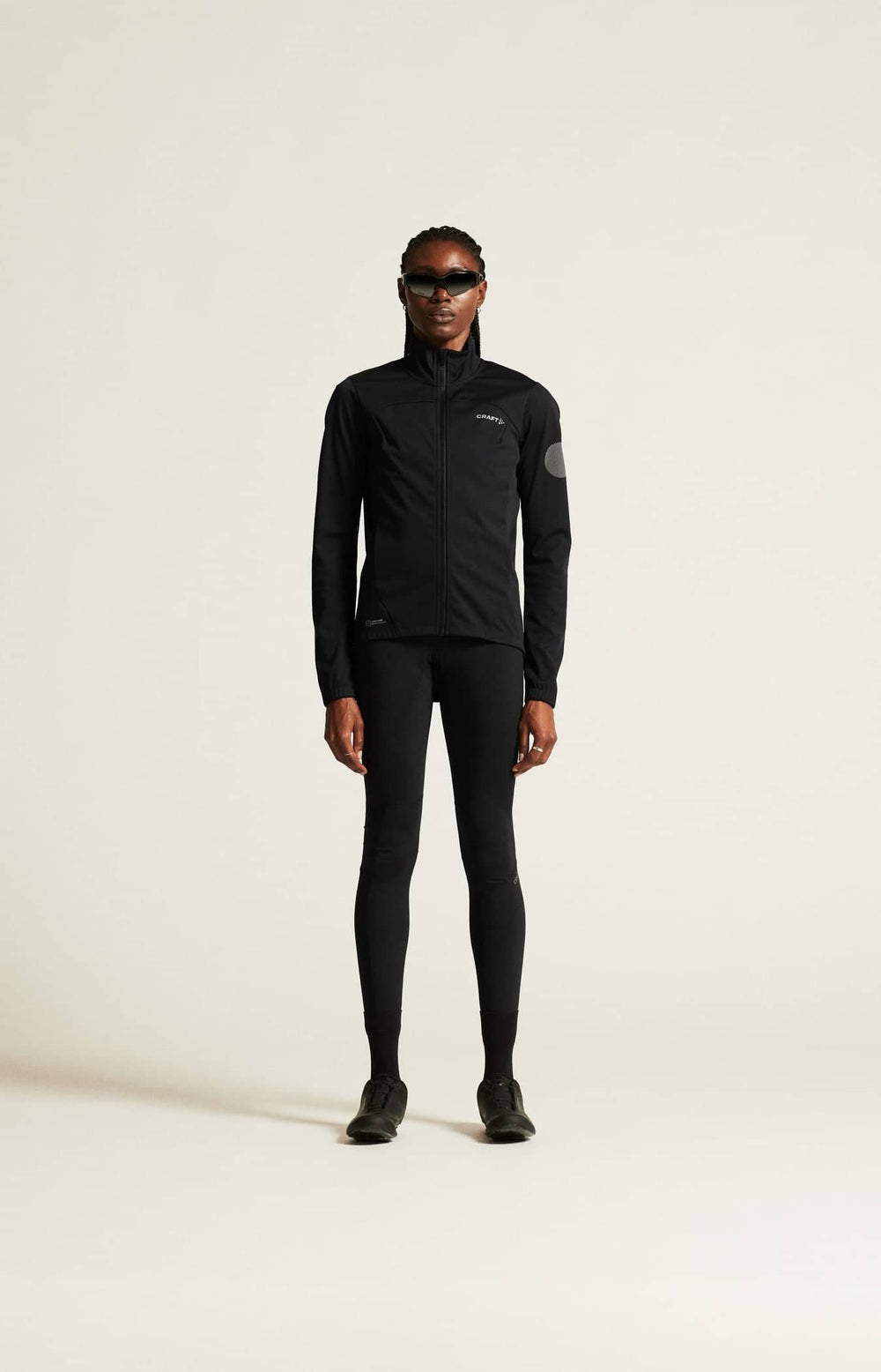 Person wearing a black athletic outfit on a white background