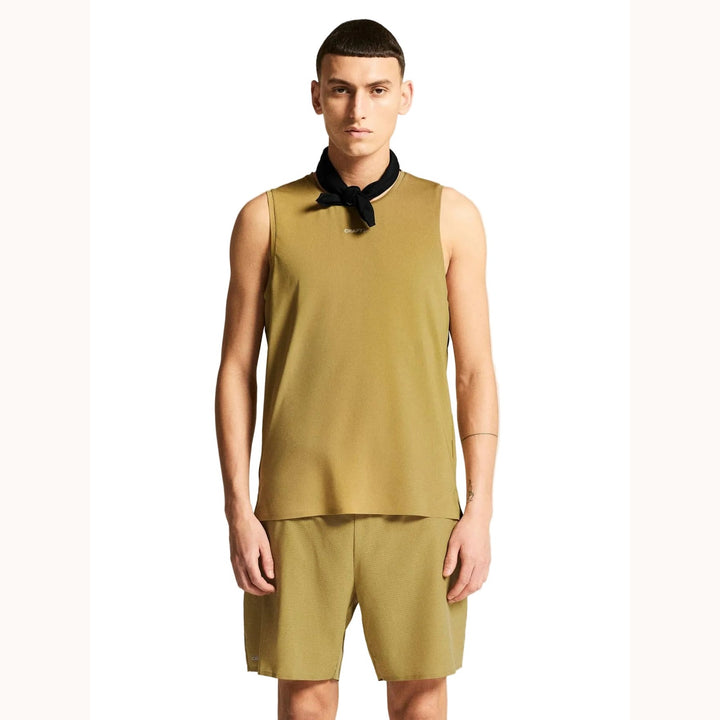 Male athlete wearing Craft Pro Trail Singlet 2 in Khaki, lightweight running singlet designed for trail running and endurance training.