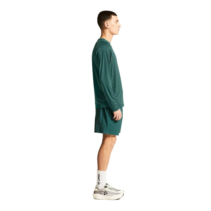 Side profile of male model wearing Craft Collective Bi-Blend LS Tee Men&