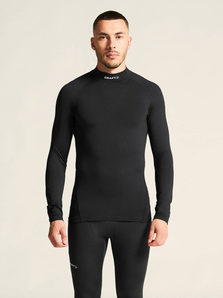 Man wearing a black long-sleeve athletic shirt with &