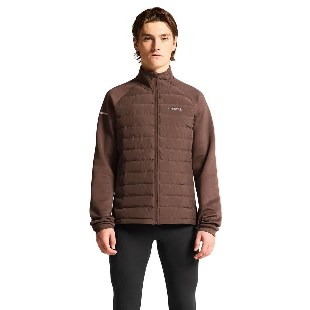 Male athlete wearing Craft SubZ Jacket 4 in Prune, cold-weather running jacket designed for warmth and outdoor training comfort.