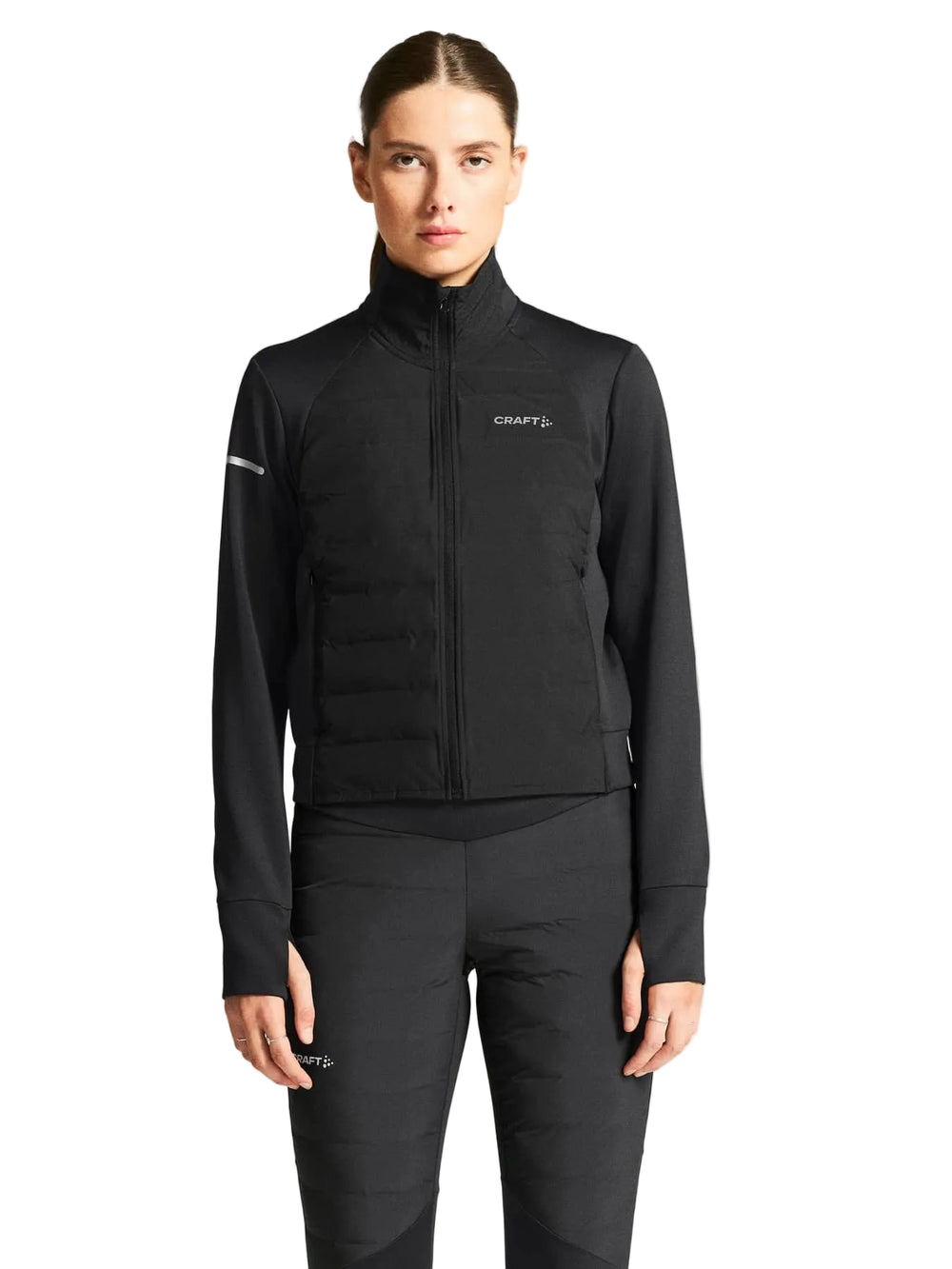 Female athlete wearing Craft SubZ Jacket 4 Women's Black Running Jacket