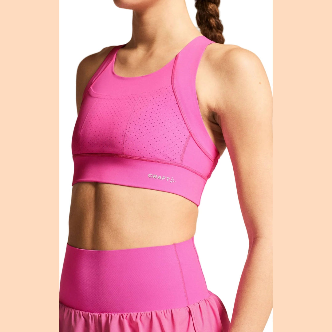Side profile of female athlete wearing Craft Hypervent Pocket Sport Top Women&