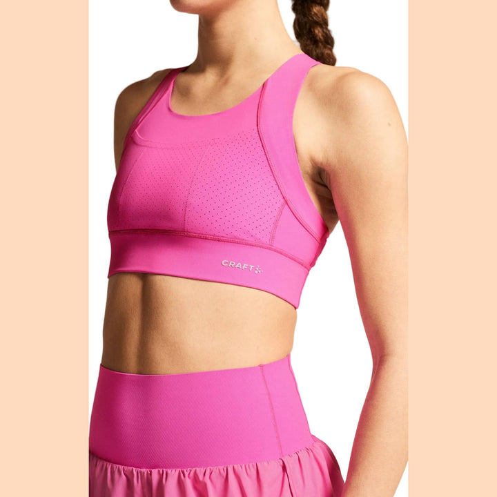 Side profile of female athlete wearing Craft Hypervent Pocket Sport Top Women&
