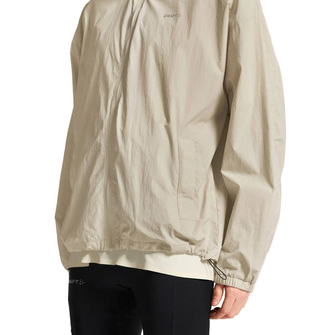 Side profile of male athlete wearing Craft Hypervent Oversized Wind Jacket Men&