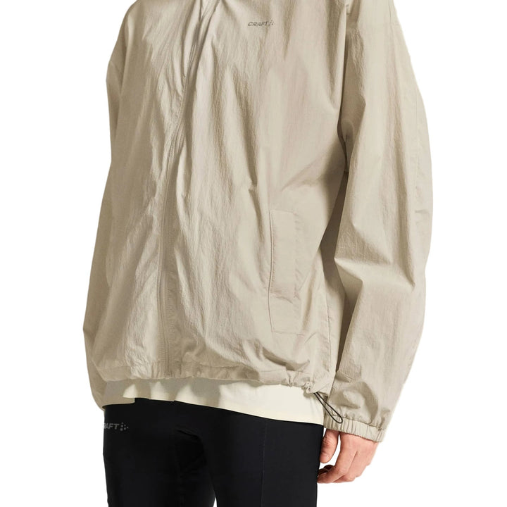 Side profile of male athlete wearing Craft Hypervent Oversized Wind Jacket Men&