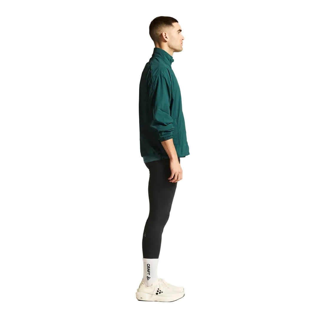 Side profile of male athlete wearing Craft Hypervent Oversized Wind Jacket Men&