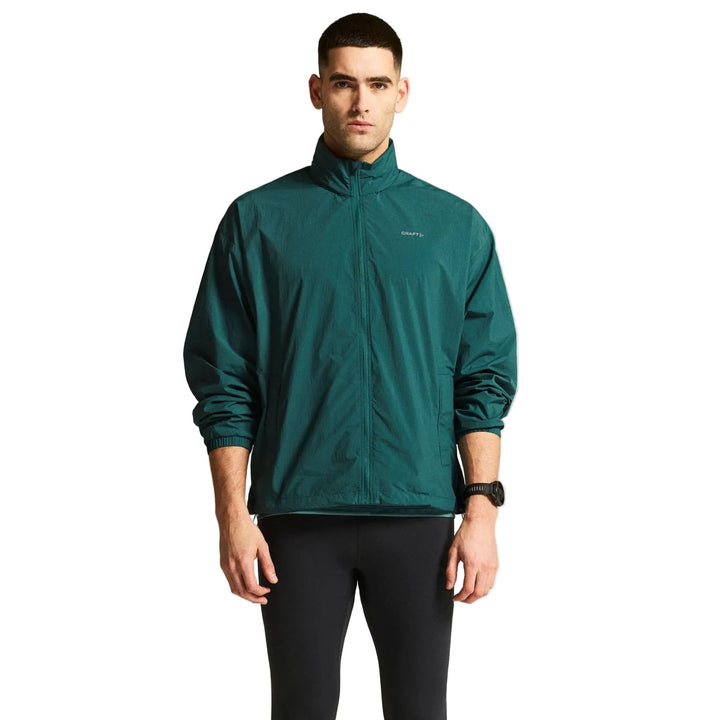 Male athlete wearing Craft Hypervent Oversized Wind Jacket in Peridot, lightweight running jacket designed for wind protection and training comfort.