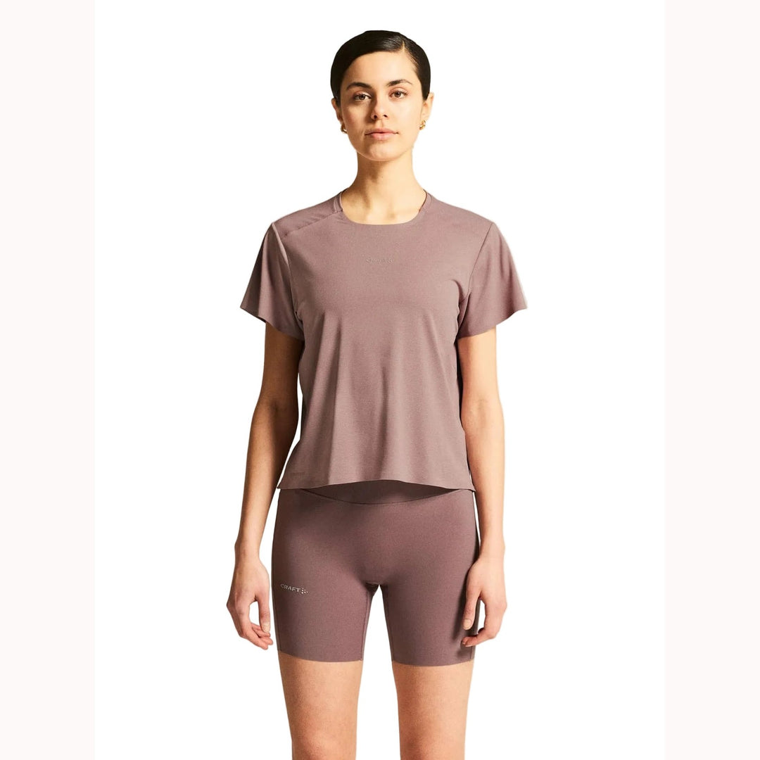 Female model wearing Craft Hypervent Tee in Potpourri, lightweight running t-shirt designed for training, fitness, and everyday workouts.