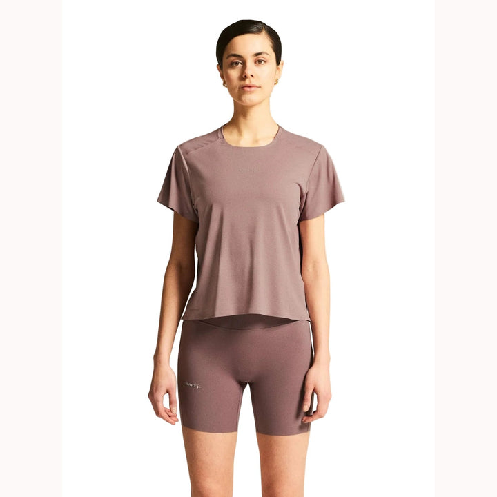 Female model wearing Craft Hypervent Tee in Potpourri, lightweight running t-shirt designed for training, fitness, and everyday workouts.