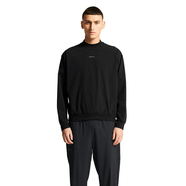 Male runner wearing Craft Hypervent Wind Top in Black, lightweight wind-protective top designed for running and outdoor training.