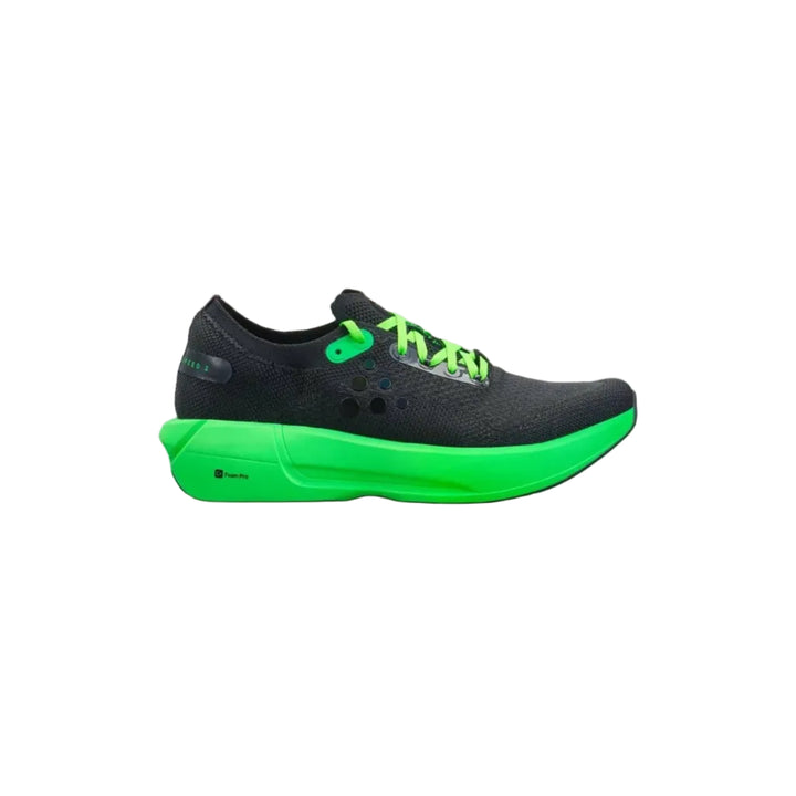 Black and green running shoe on a beige background