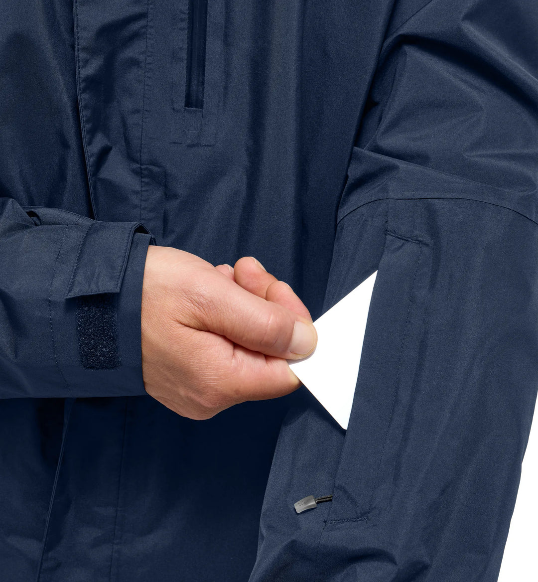 Close-up of a person wearing a navy blue jacket with a white background