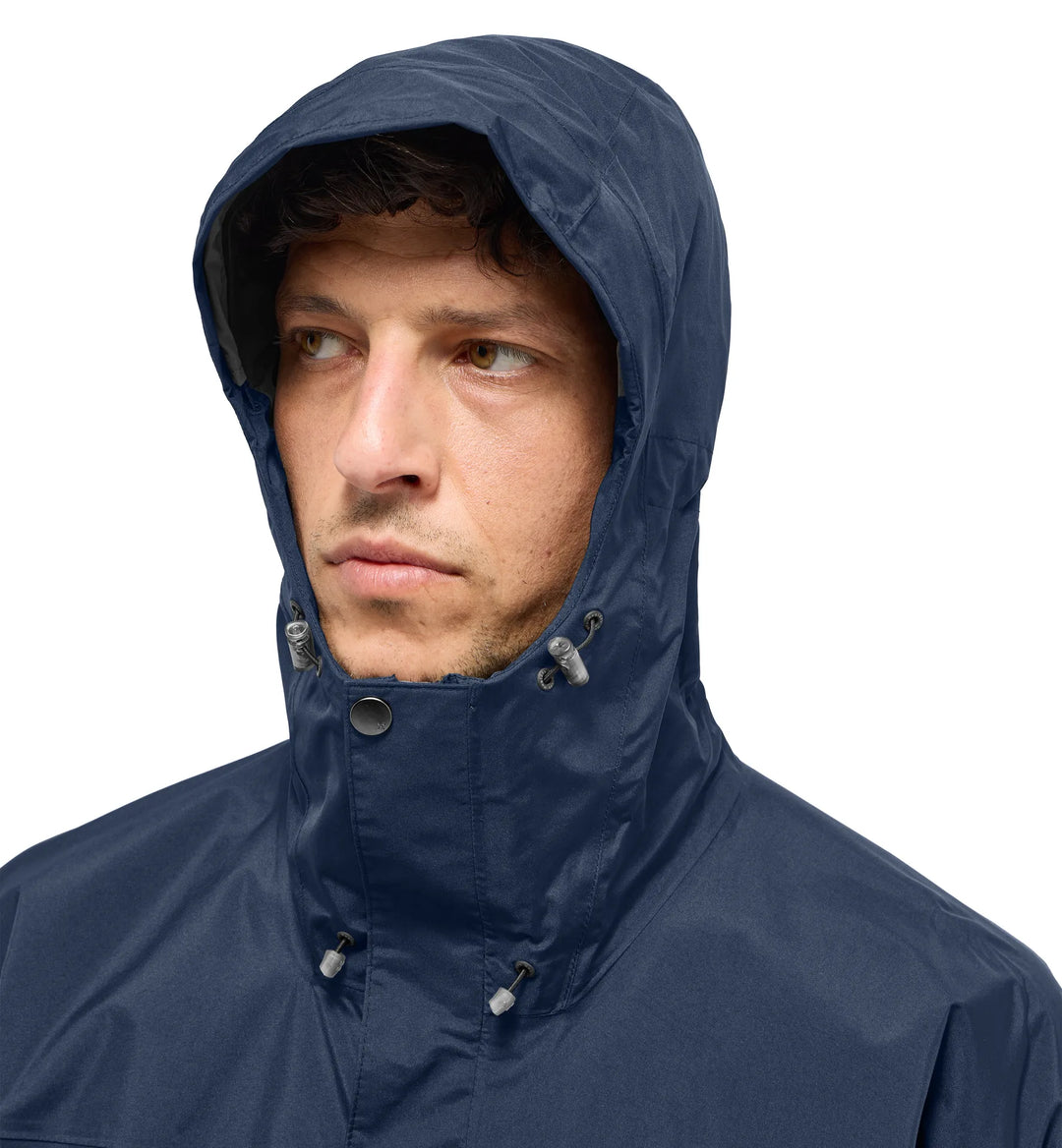 Man wearing a navy blue raincoat with a hood on a white background