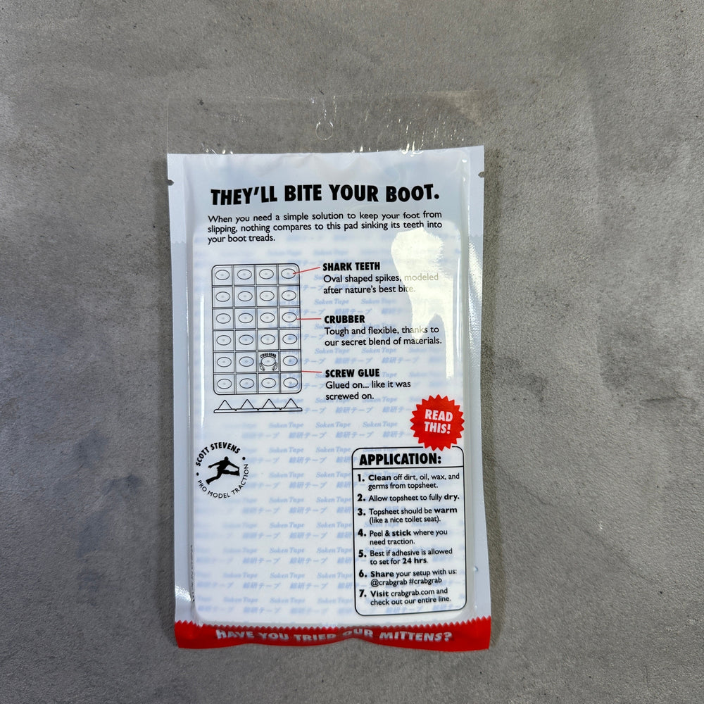 Small rectangular package with text and a logo on a gray surface