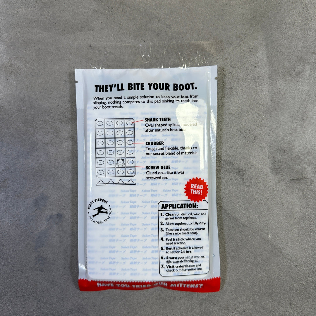 Small rectangular package with text and a logo on a gray surface