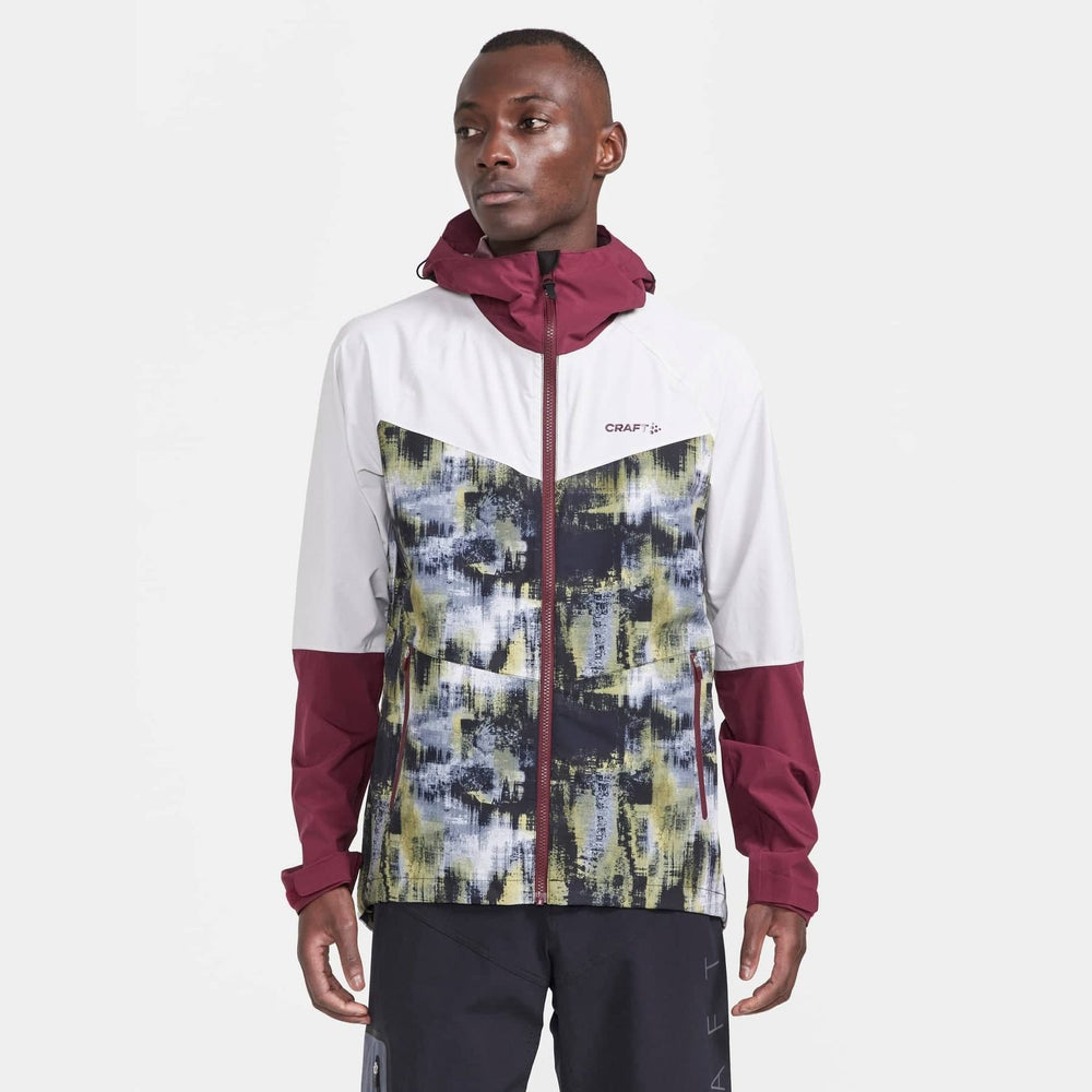 Man wearing a colorful jacket with a white background