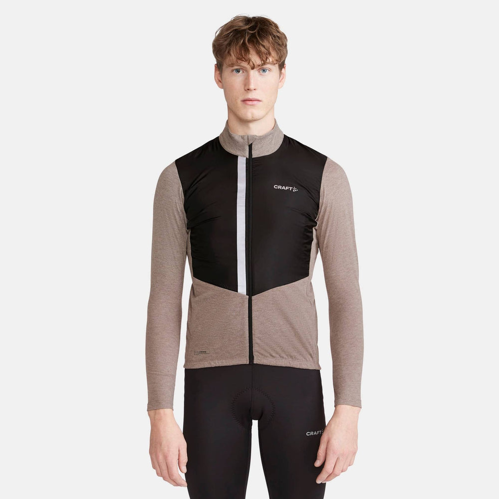 Person wearing a black and brown cycling outfit with 'Craft' branding on a white background