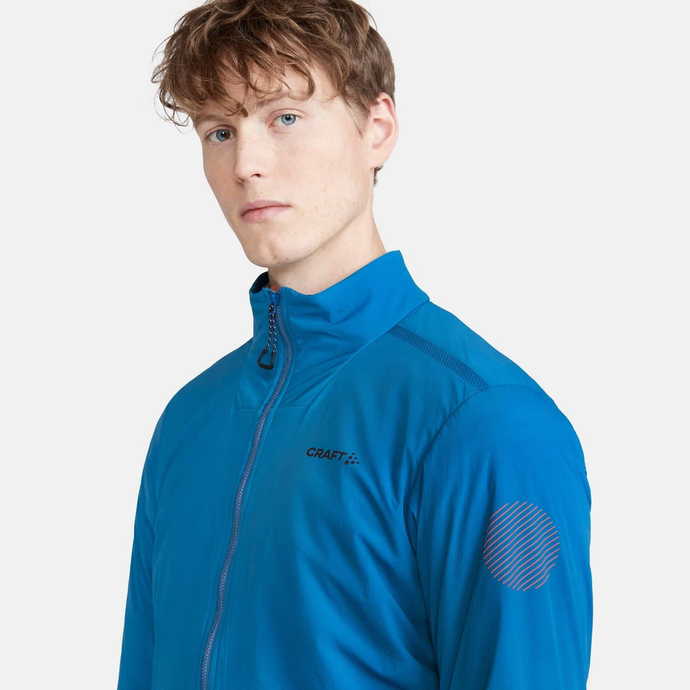 Person wearing a blue jacket with 'Craft' branding on a white background