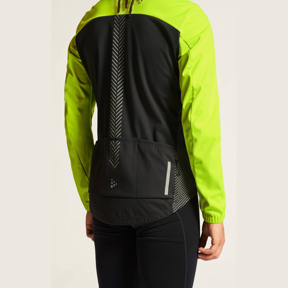 Person wearing a bright green jacket with a black back panel on a white background