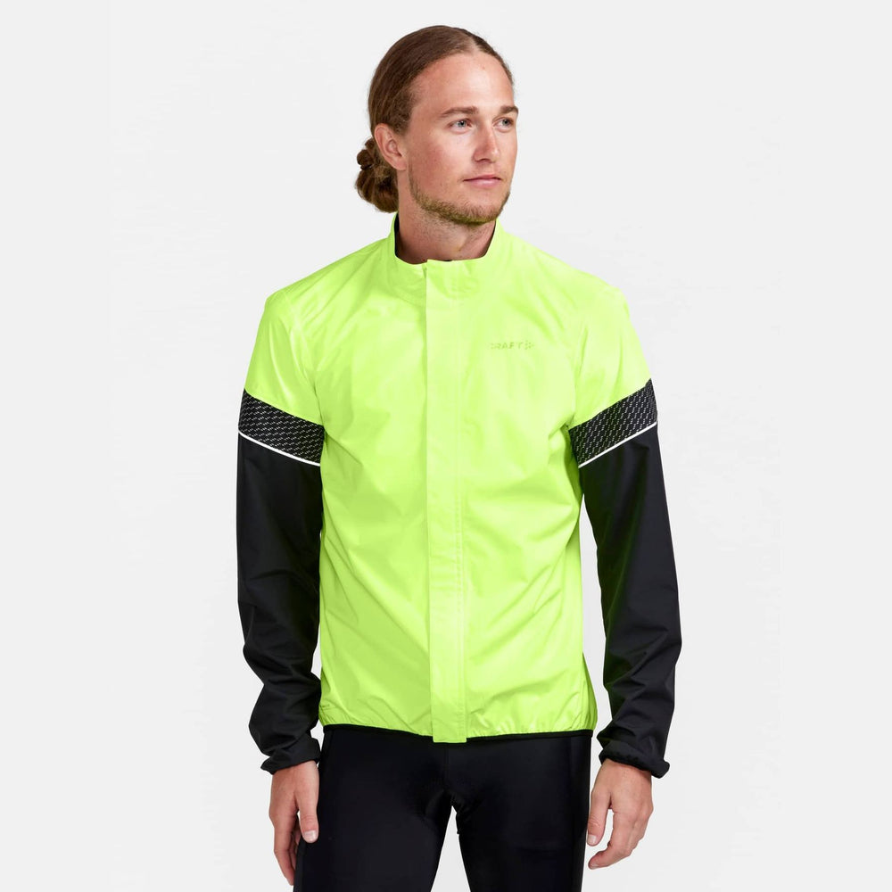 Person wearing a bright yellow-green jacket with black sleeves on a white background