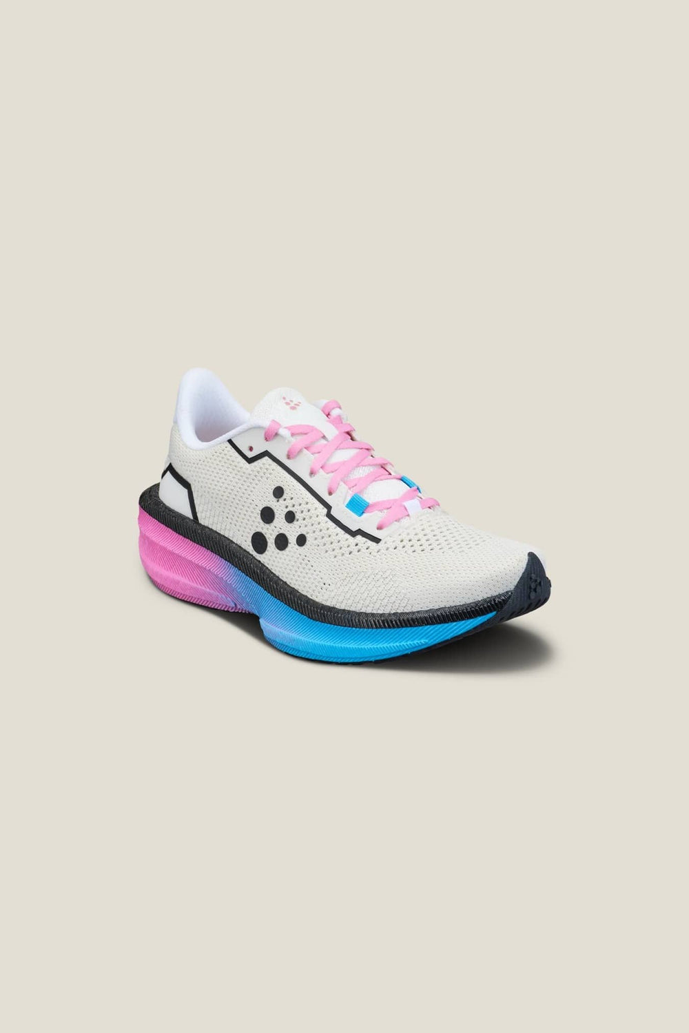 White running shoe with pink laces on a beige background