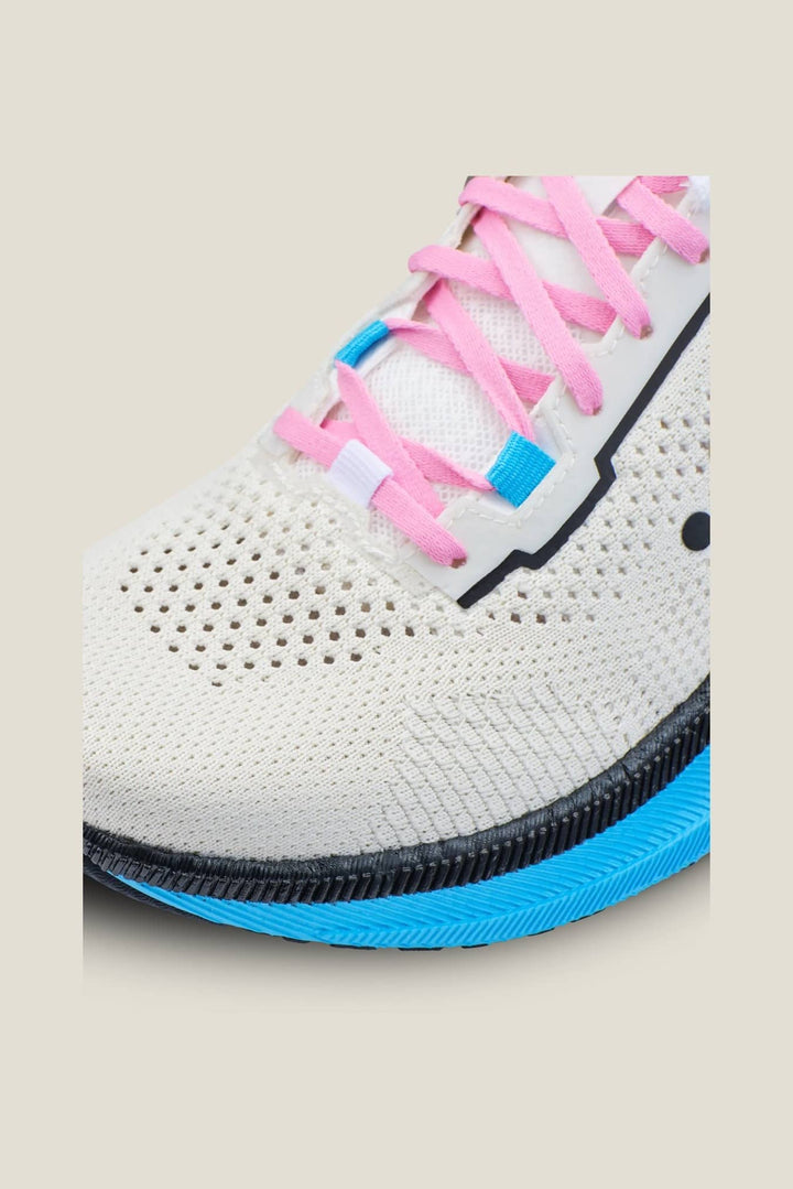 White sneaker with pink and blue laces on a beige background