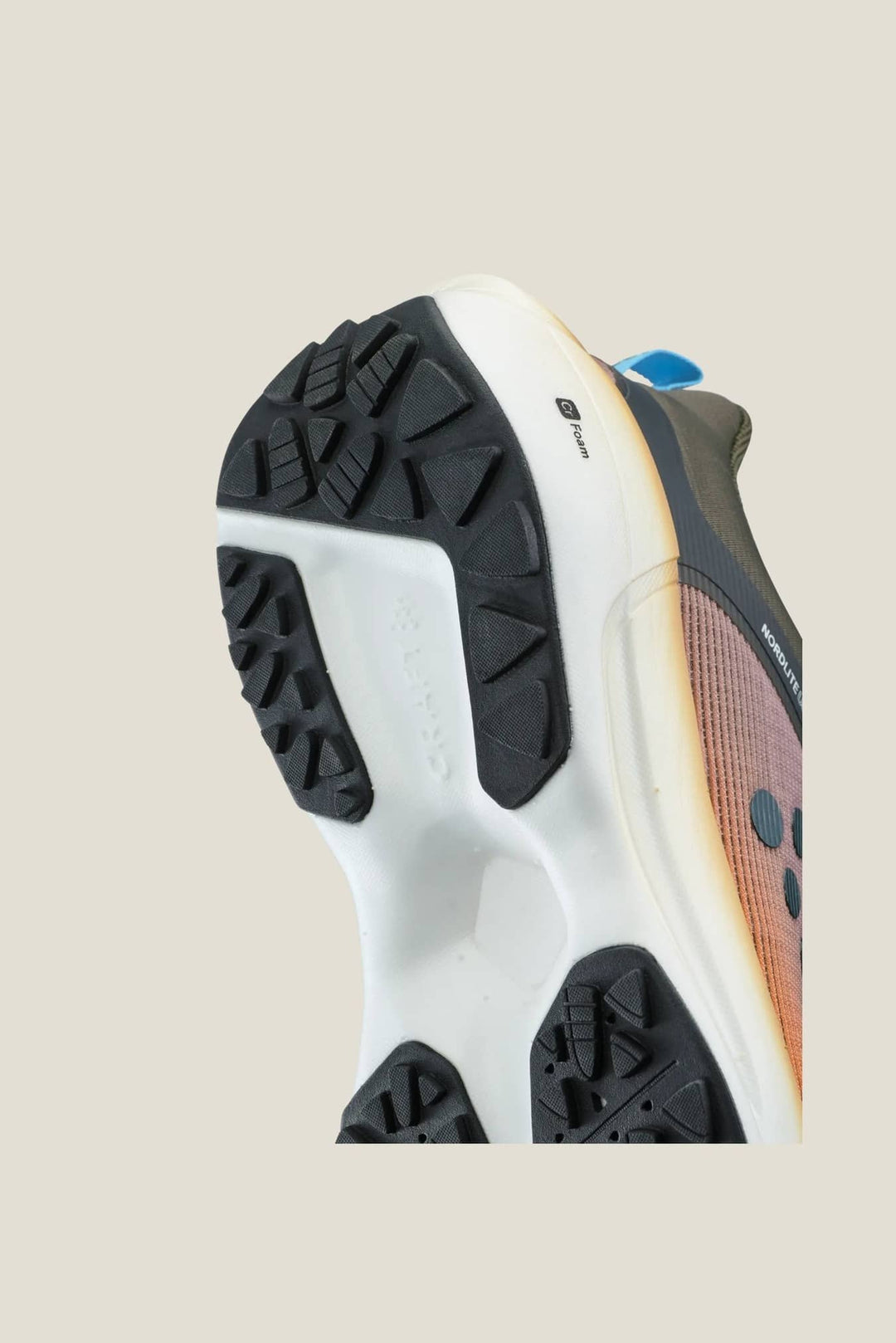 Close-up of a running shoe with a focus on the sole and brand logo.