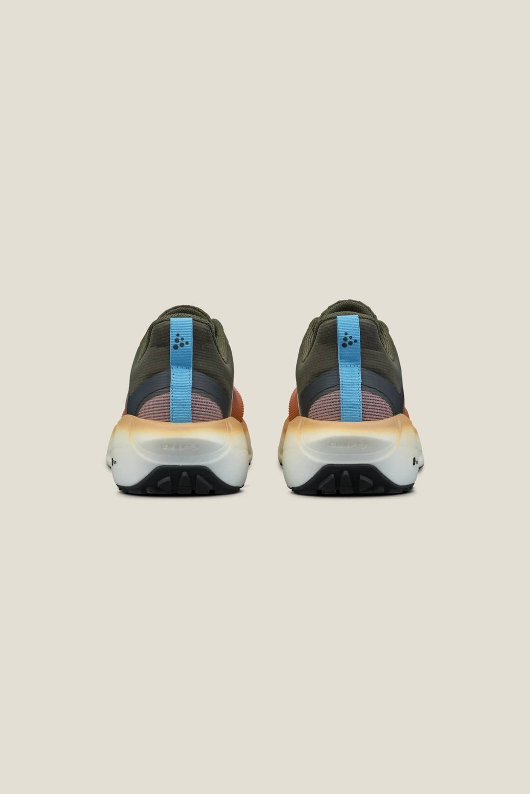 Pair of black athletic shoes with blue accents on a beige background