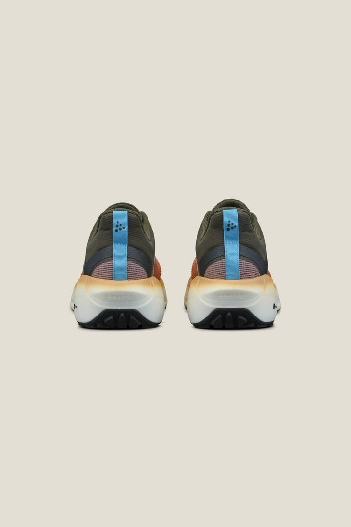 Pair of black athletic shoes with blue accents on a beige background