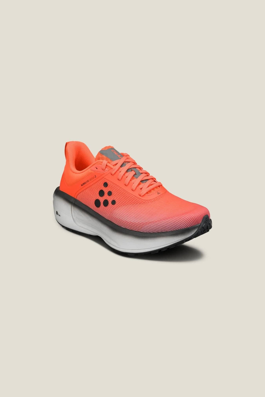 Orange running shoe on a beige background