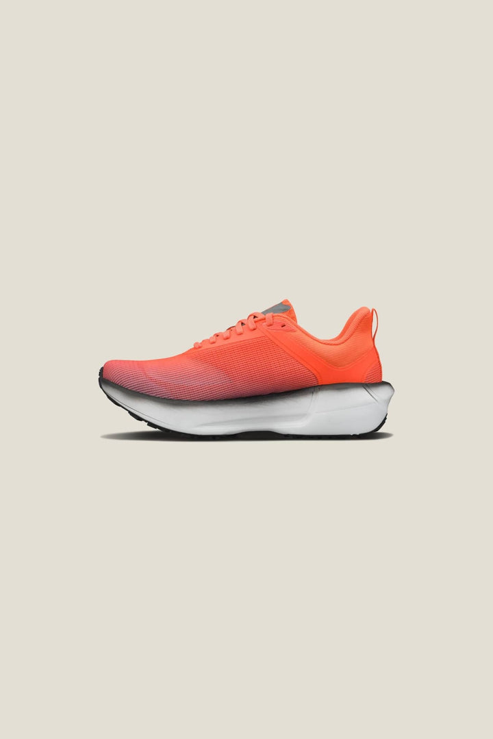 Orange running shoe on a beige background