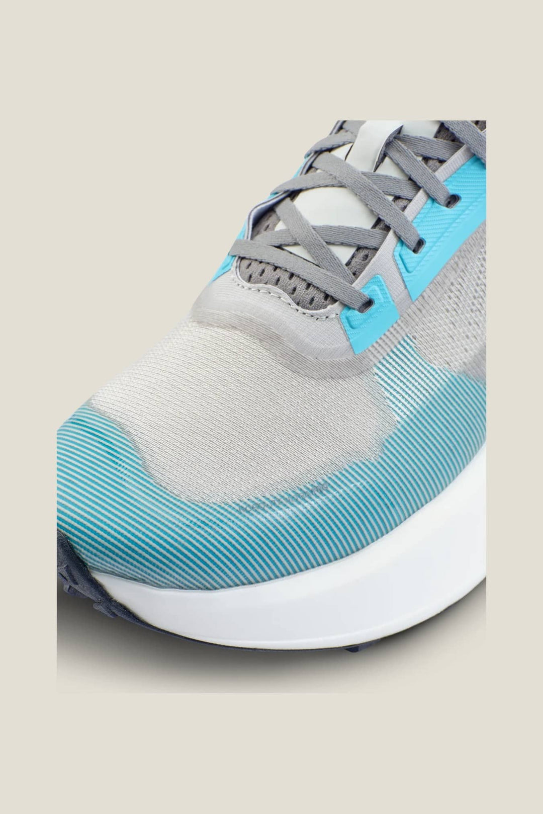 Gray and blue athletic shoe on a beige background