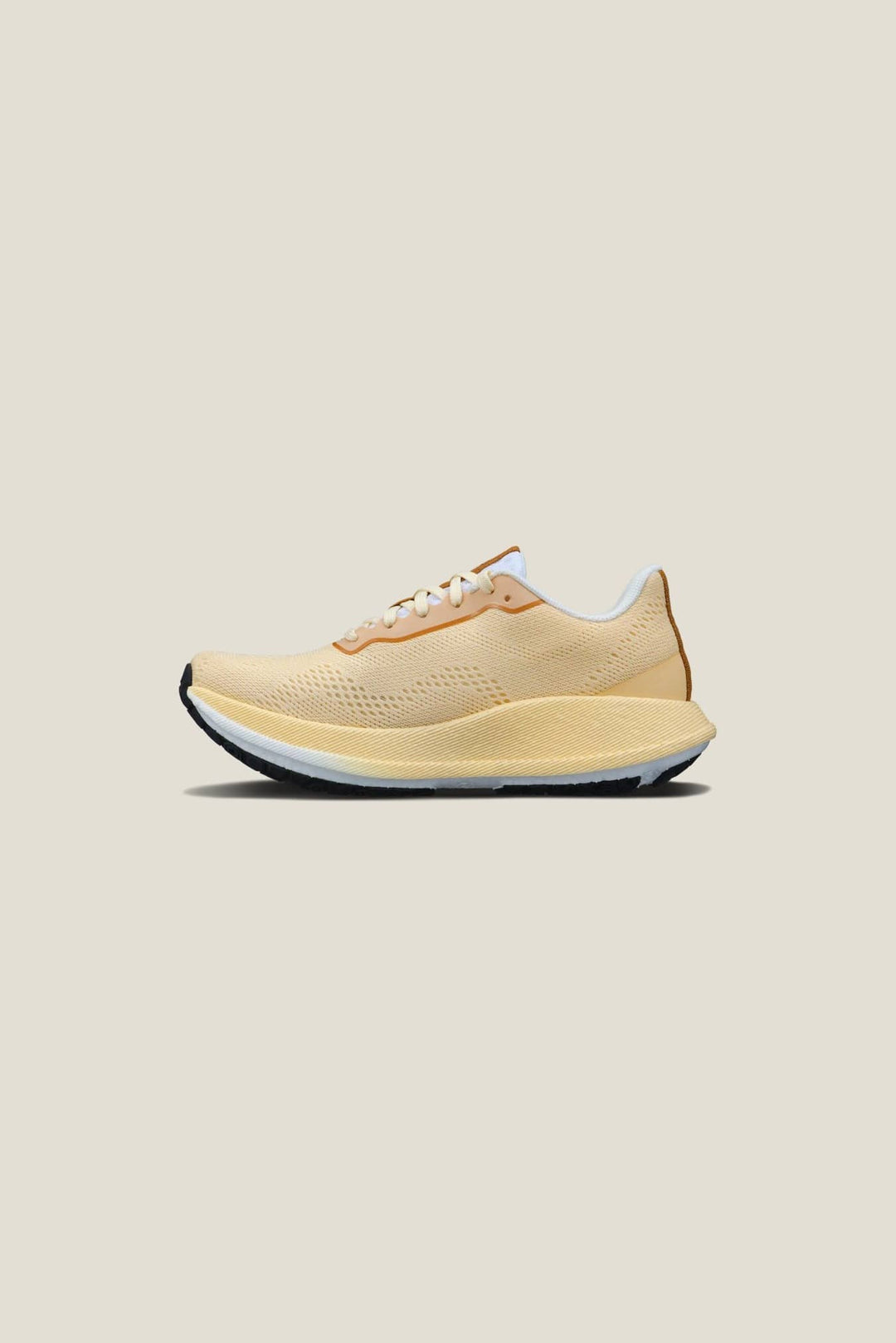Yellow running shoe on a beige background