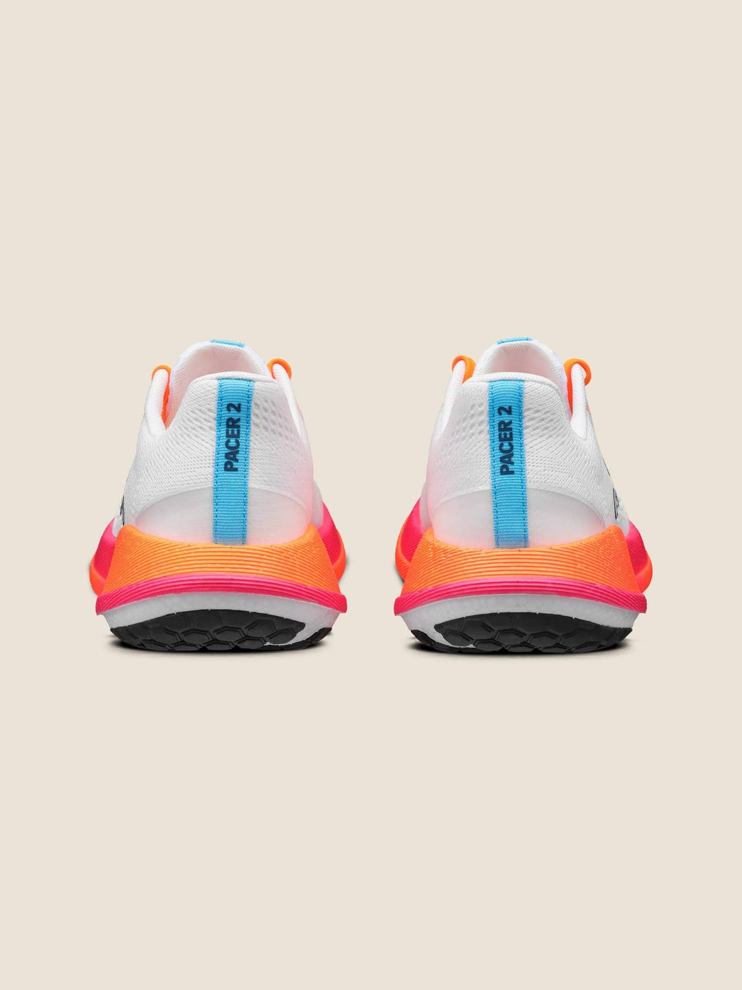 White running shoes with orange and pink accents on a beige background